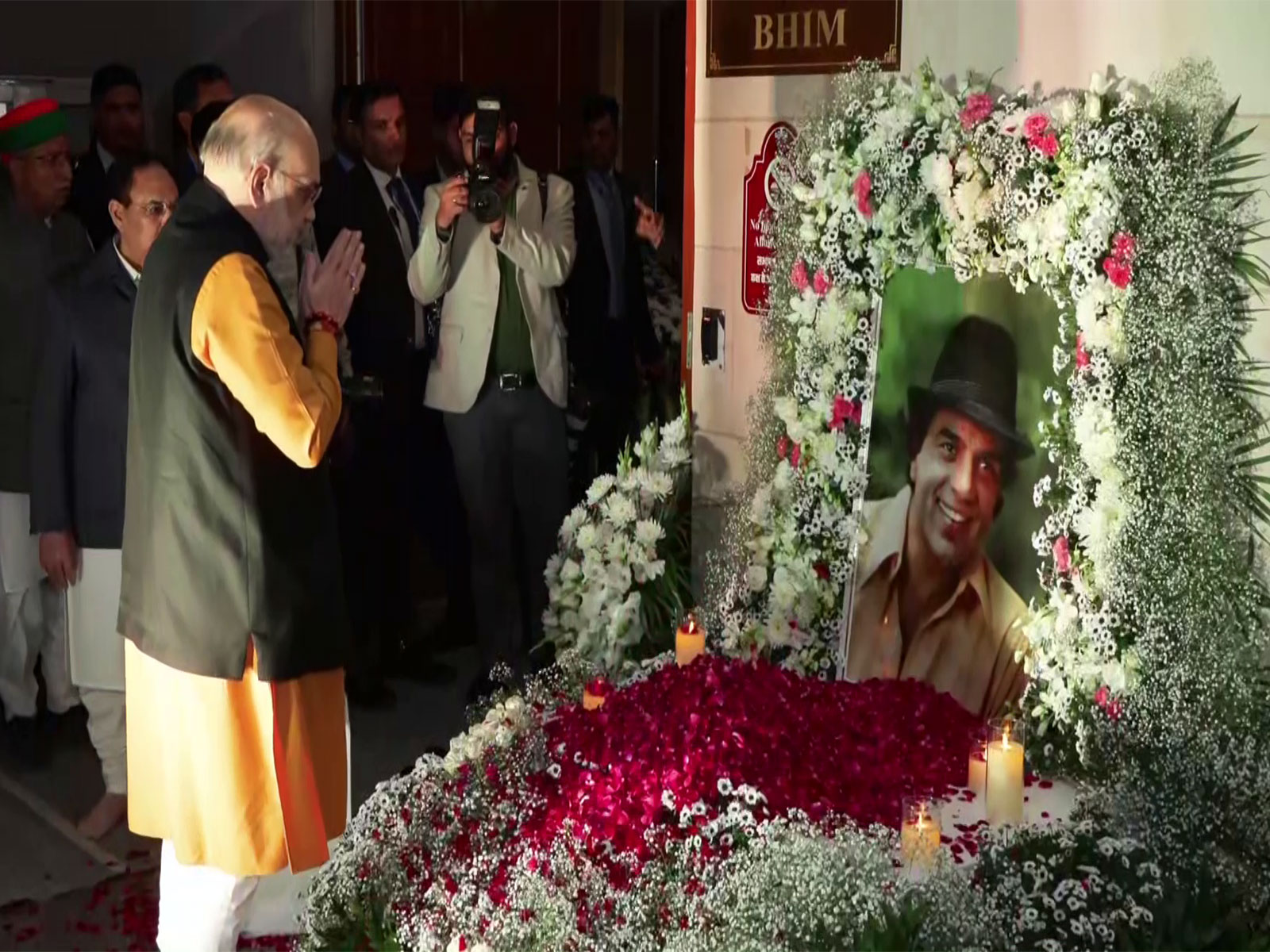 Union Home Minister Amit Shah paying floral tribute to late actor Dharmendra at a prayer meet in Delhi on Thursday evening. (Photo/ANI)
