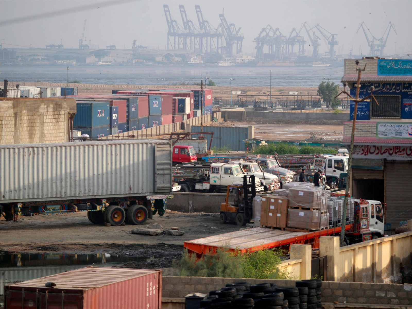 Trucks and containers are parked in a compound at the main port of Karachi (File Photo/ Reuters)