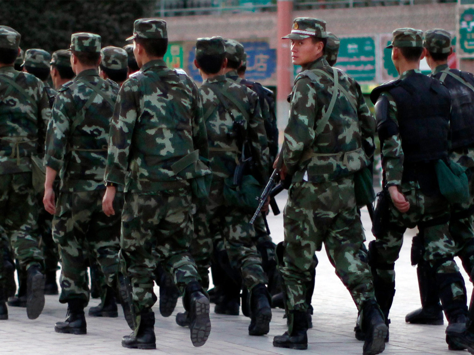 Armed police officers patrol an ethnic Uighur area (File Photo/ Reuters)