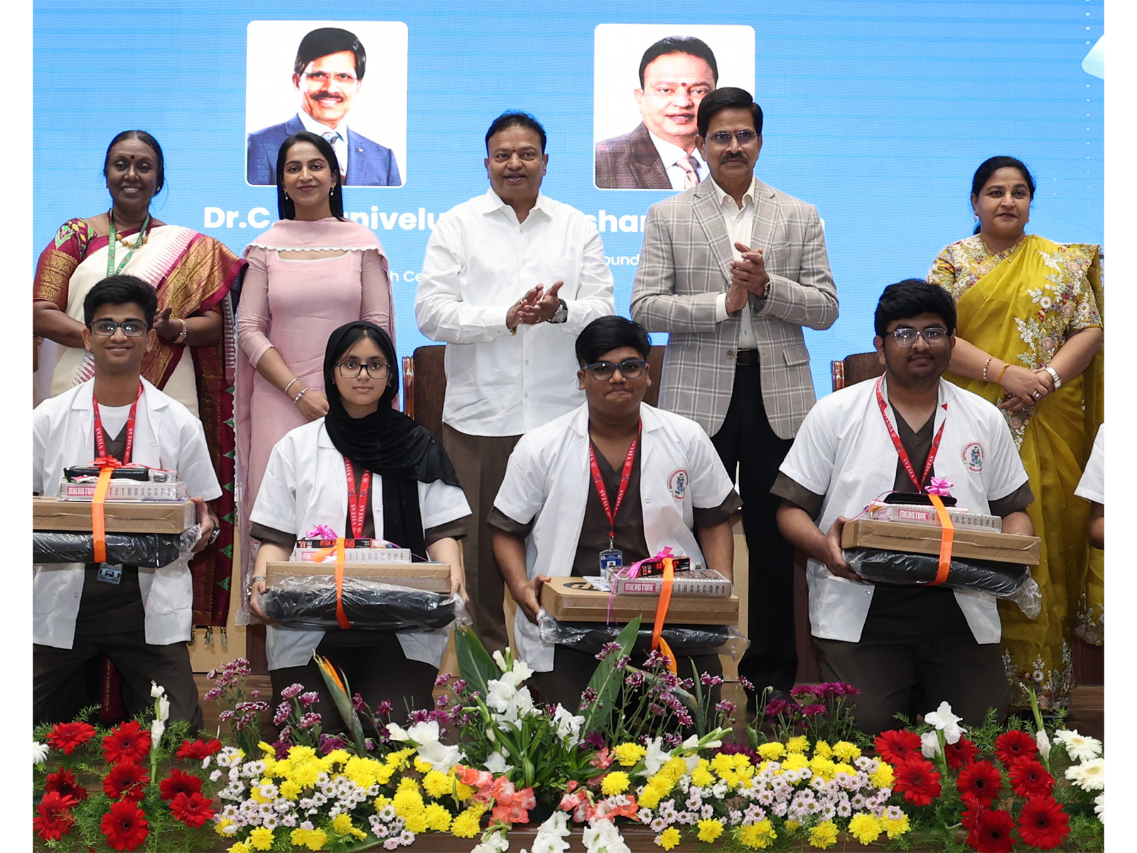 Newly inducted MBBS students receive academic kits during the White Coat Ceremony at VELS Medical College & Hospital, in the presence of Founder-Chancellor Dr. Ishari K. Ganesh