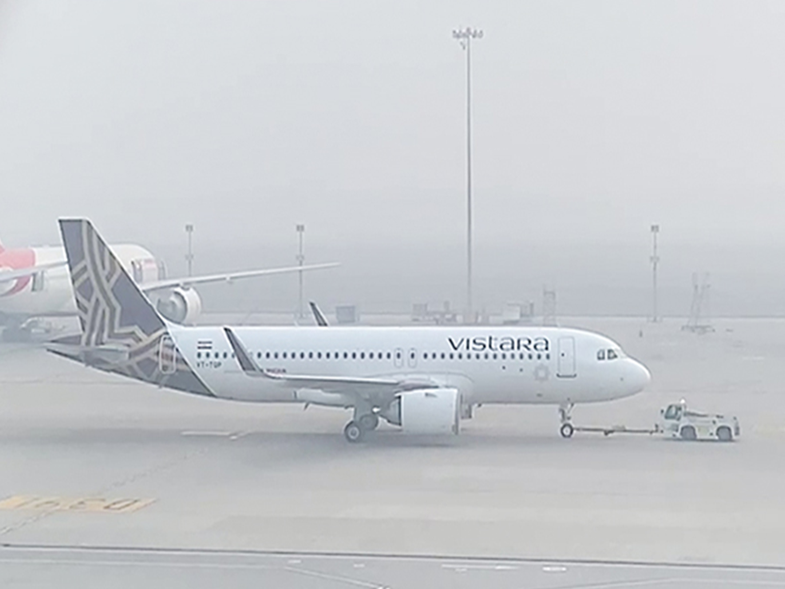 An aircraft waits to take off at the runway as dense smog reduce visibility and engulfs IGI airport. (Photo/ANI)