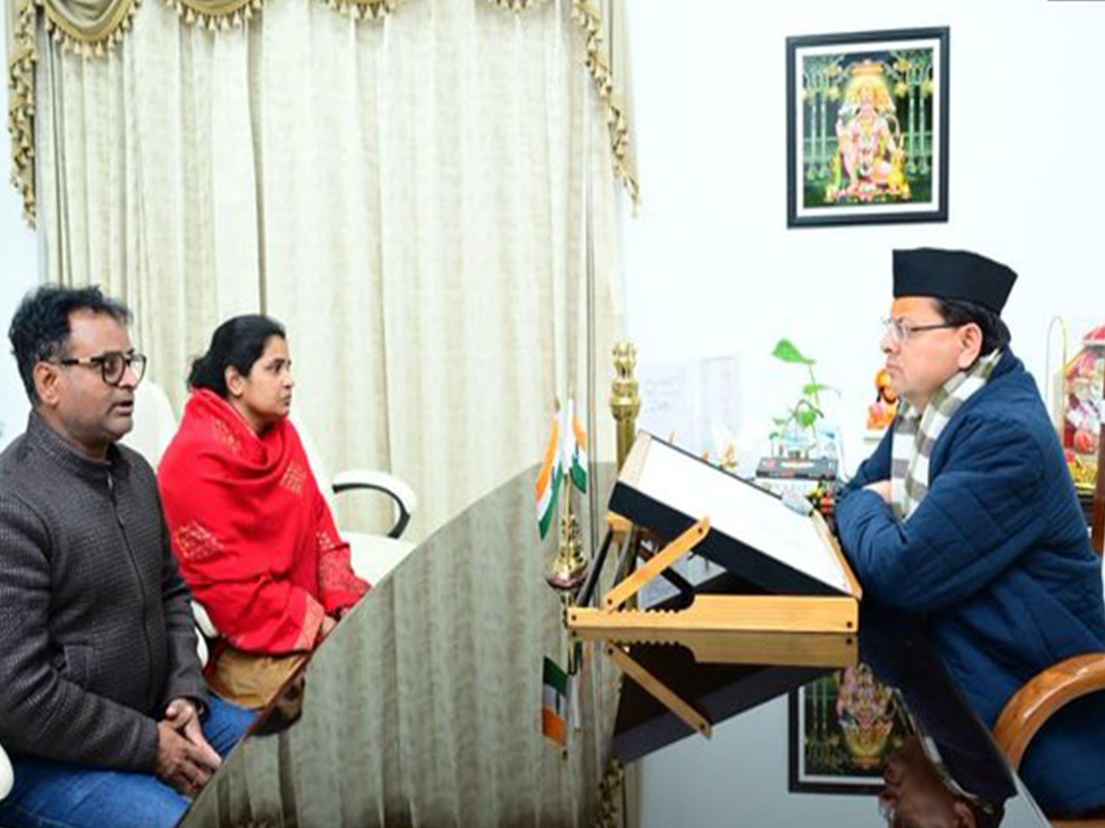 Chief Minister Pushkar Singh Dhami with wife and brother of late journalist Pankaj Mishra (Photo/ANI)