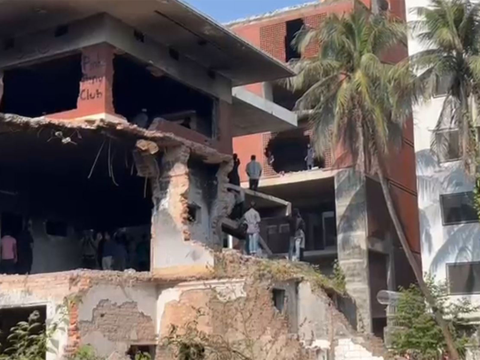 Protestors attempt to tear down remains of Sheikh Mujibur Rehman's partially destroyed house (Photo/ANI)