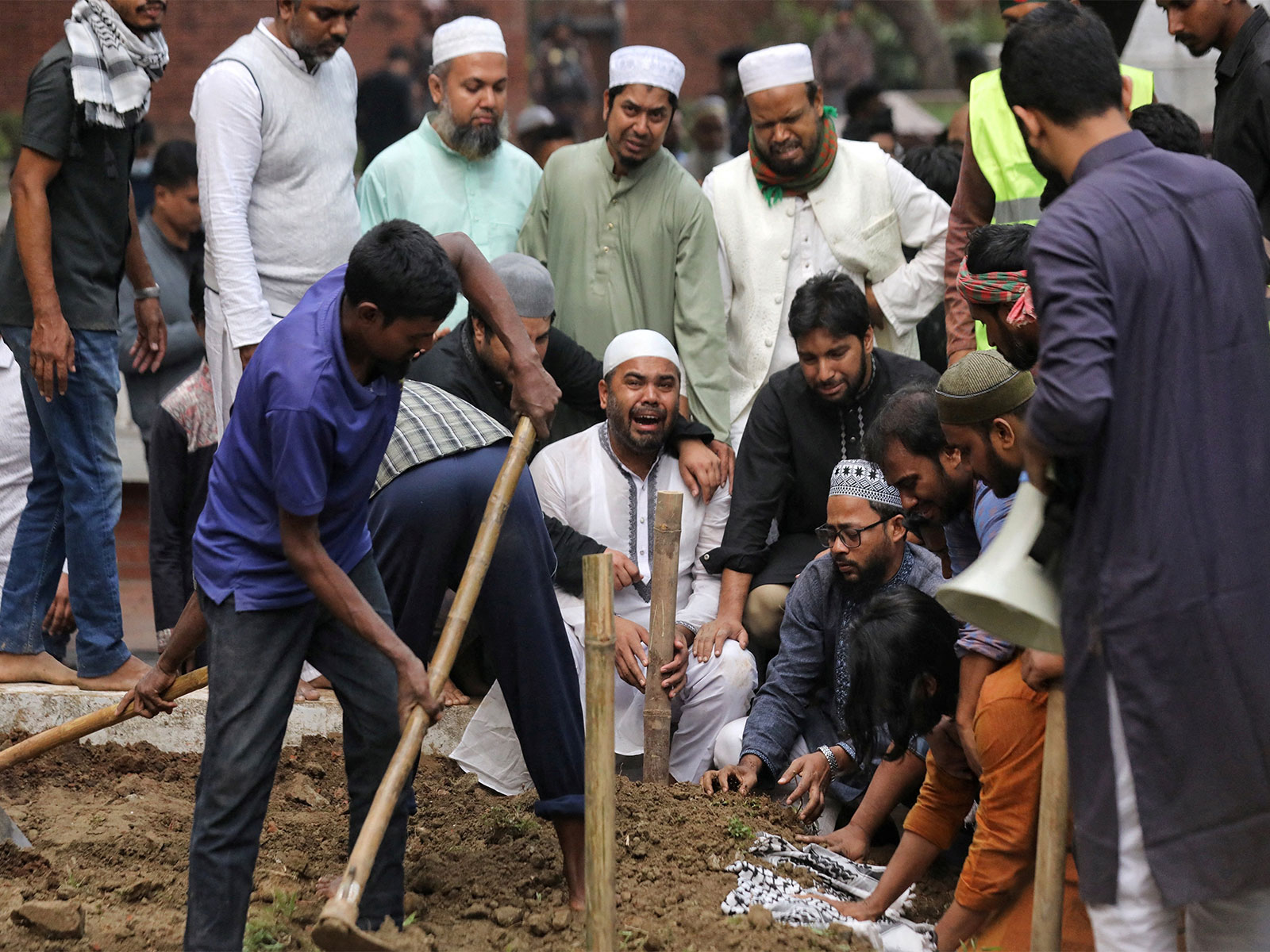 Omar Faruk, brother of Sharif Osman Hadi, a student leader who died after being shot in the head, mourns during the burial, in Dhaka (Photo/Reuters)