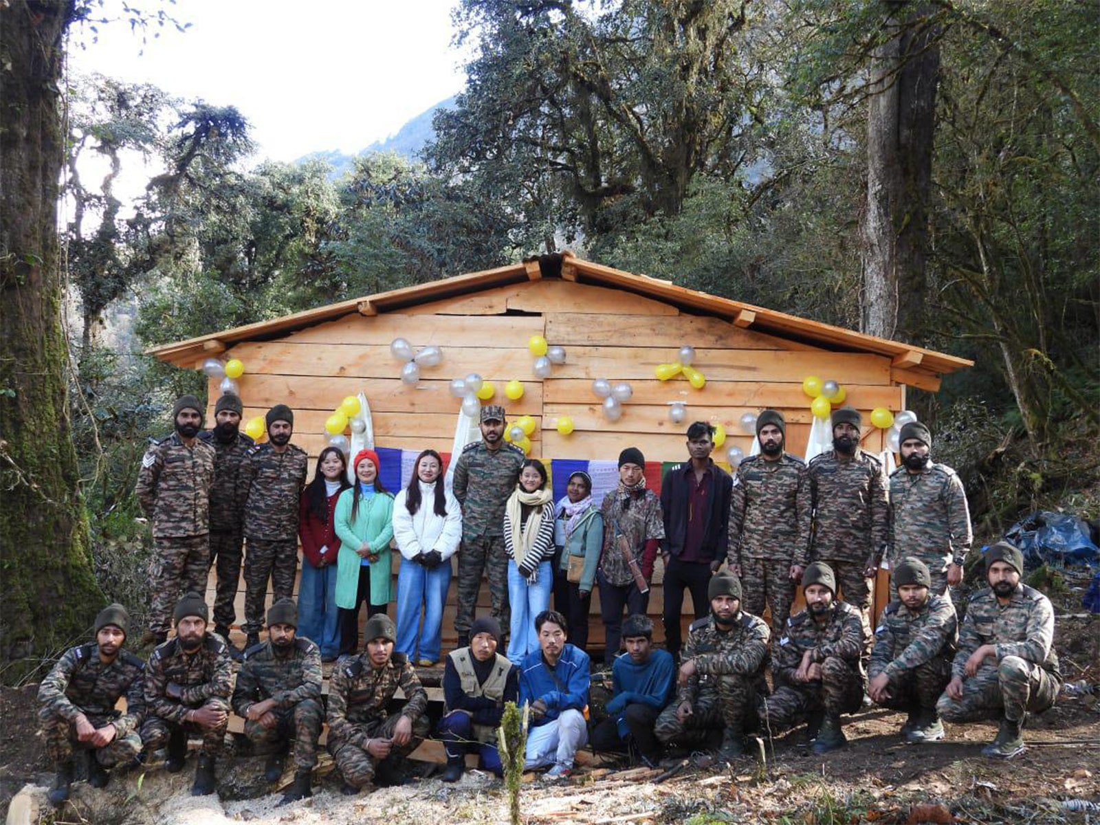 Indian Army troops with locals infront of log hut Ojugo village (Photo/ANI)
