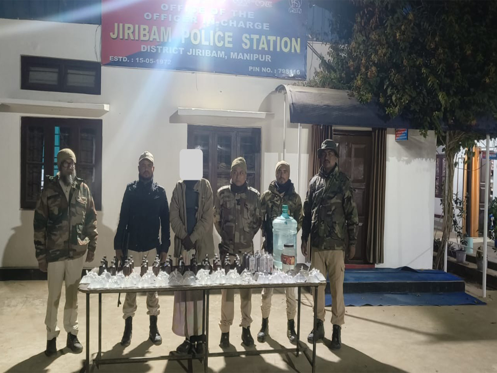 Manipur Police with seized DIC liquor and IMFL bottles after apprehending a man from Latingkhal Part-II in Jiribam district (Photo: x/@manipur_police)