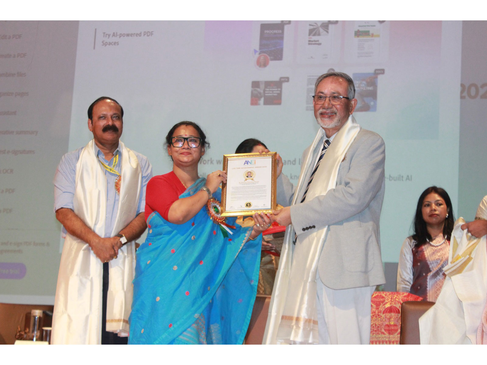 Dr. Nomal Chandra Borah receiving the ANEI Lifetime Achievement Award from Ms. Loni Borpatra Gohain (Government of Assam) in the presence of Prof. Ashok Puranik (AIIMS Guwahati)