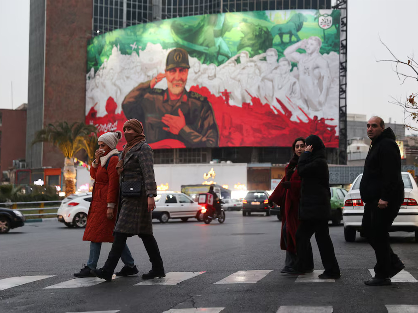 People move along a street in Tehran as protests break out over the sharp fall in the value of the national currency (Photo/Reuters)