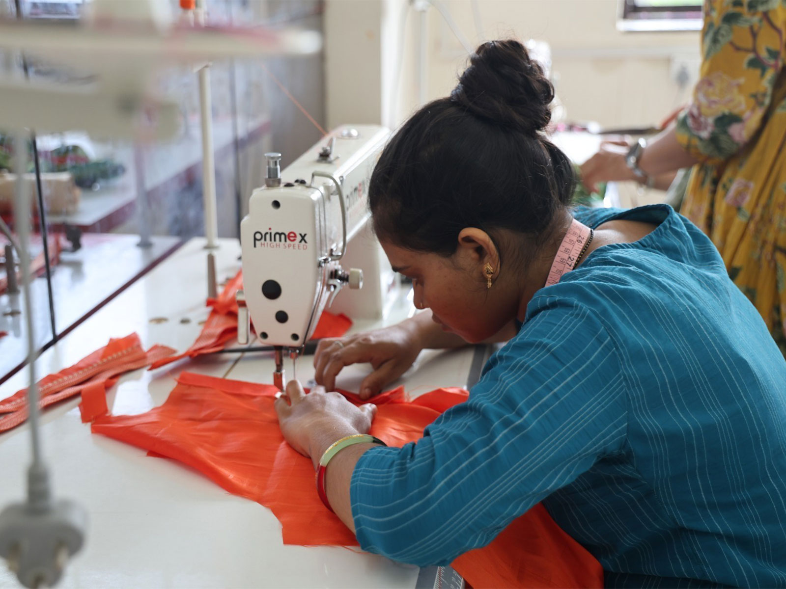 A woman stitching clothes for the Shree Somnath Trust's Vastra Prasad initiative. (Photo/Gujarat CMO)