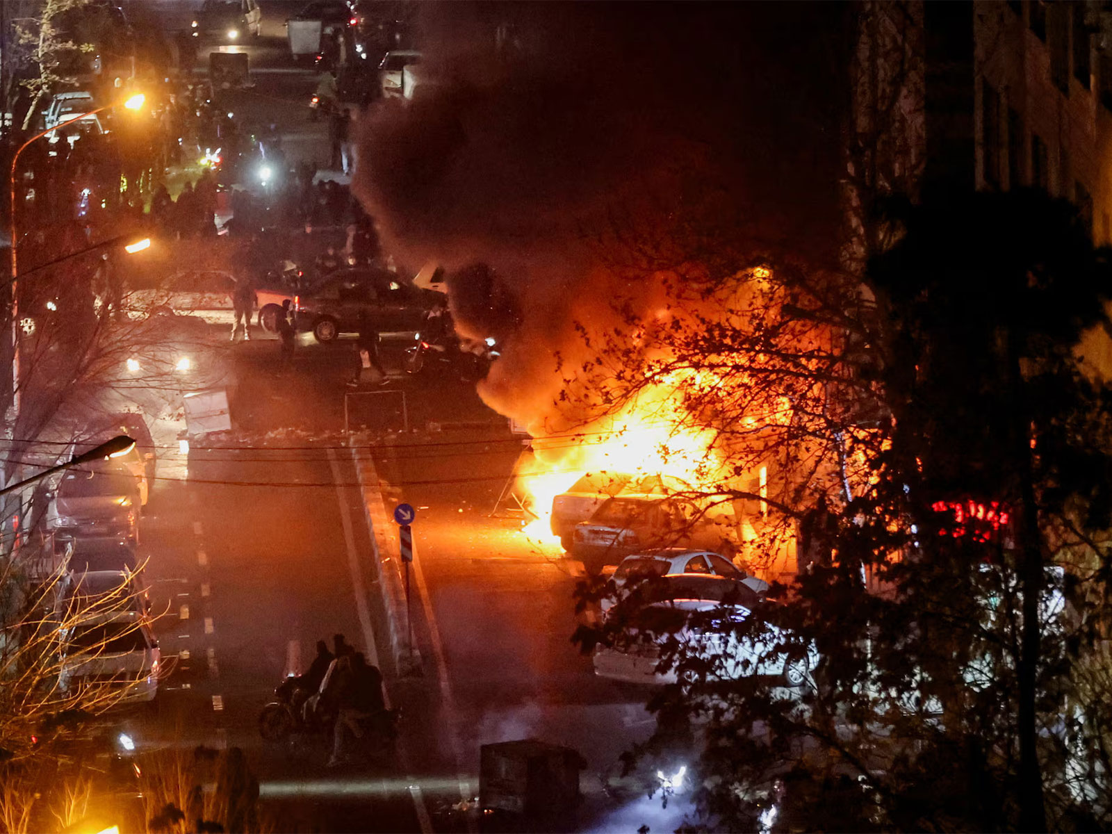 Cars burn during protests over the collapse of the currency's value in Tehran, Iran. (Photo/Reuters)