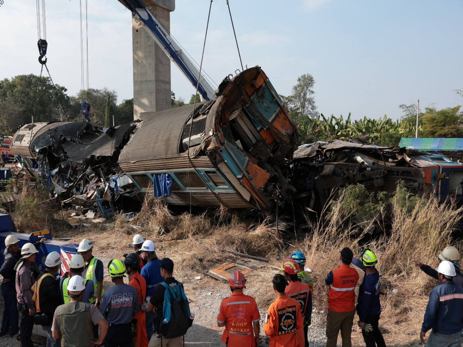 Rescue officials work at the site where a train was derailed when a construction crane collapsed and fell onto its carriages, causing several casualties, in Sikhio district, Nakhon Ratchasima province, Thailand, January 14, 2026. (Photo/Reuters)