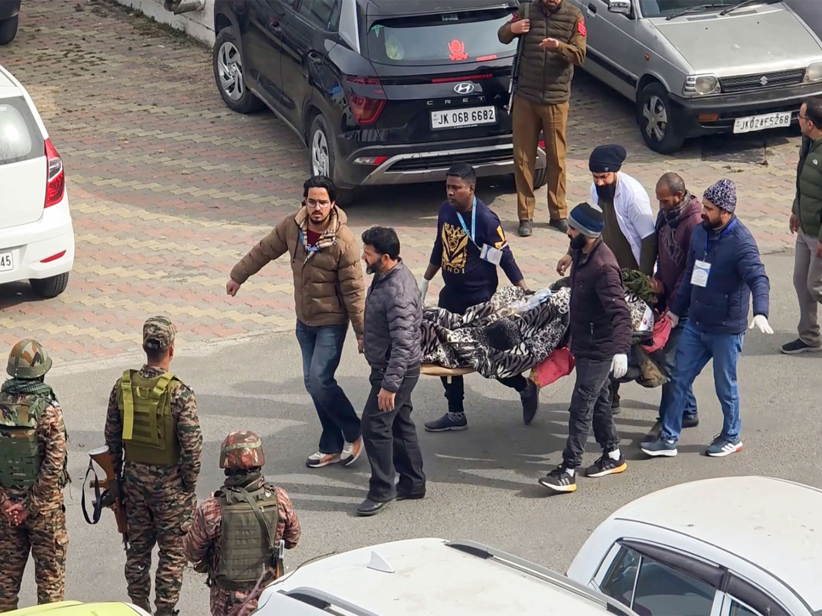 People carry the injured to the helicopter for specialised treatment at Udhampur district (Photo/ANI)