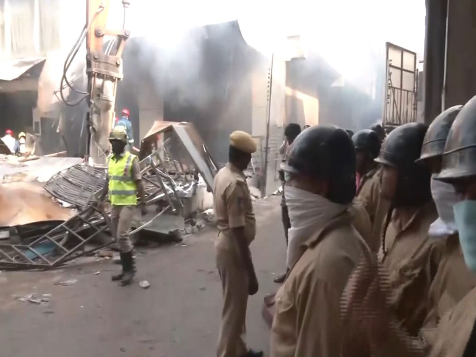 Police officials at the spot of the fire incident in Nampally. (Photo/ANI)