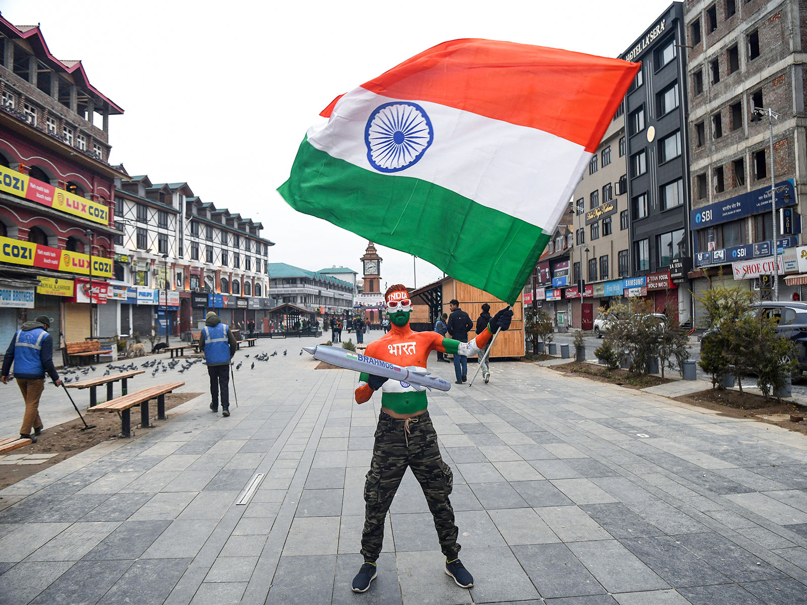 Arun from Ahmedabad waves the national flag with a BrahMos model on the occasion of 77th Republic Day at Lal Chowk, in Srinagar  (Photo/ANI)