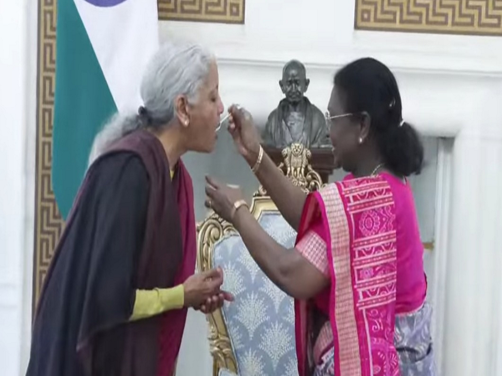 President Droupadi Murmu feeds Nirmala Sitharaman the customary 'dahi-cheeni'. (Photo/DD)
