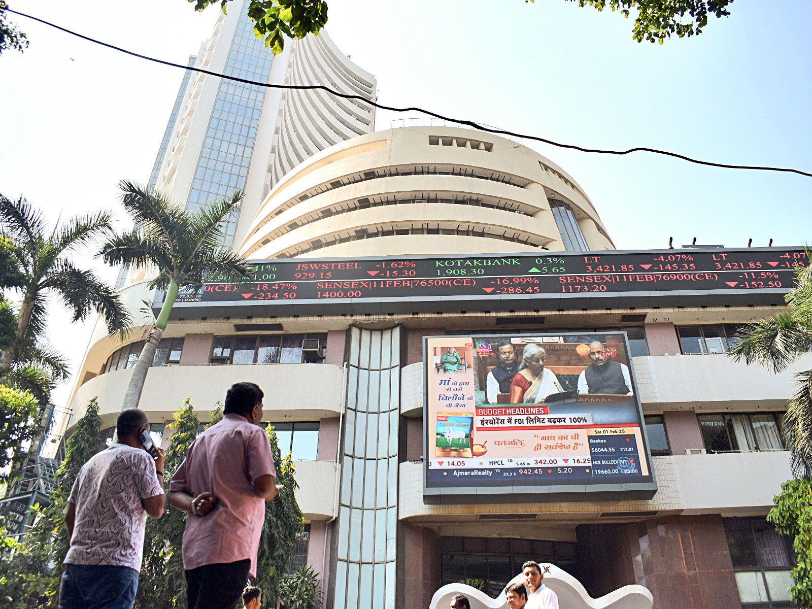 People watch the live telecast of Union Budget on a display screen outside BSE (File Photo/ANI)