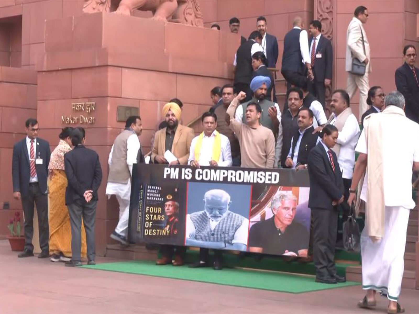 Congress MPs holding a poster 'PM is compromised' protest at the stairs of Parliament (Photo/ANI)