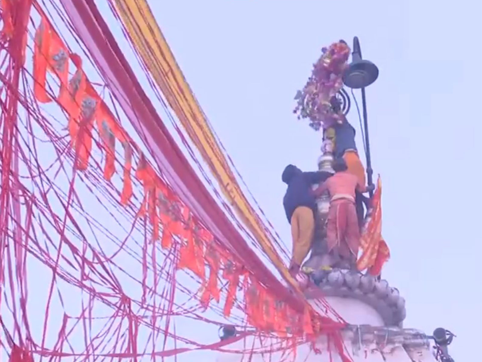 Mor Mukut being tied to the main peak of the Baba Baidyanath Temple (Photo: ANI)