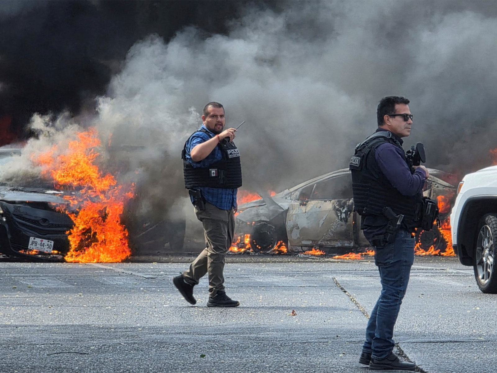 Police officers secure the area where vehicles were set on fire following killing of El Mencho (File Photo/Reuters)
