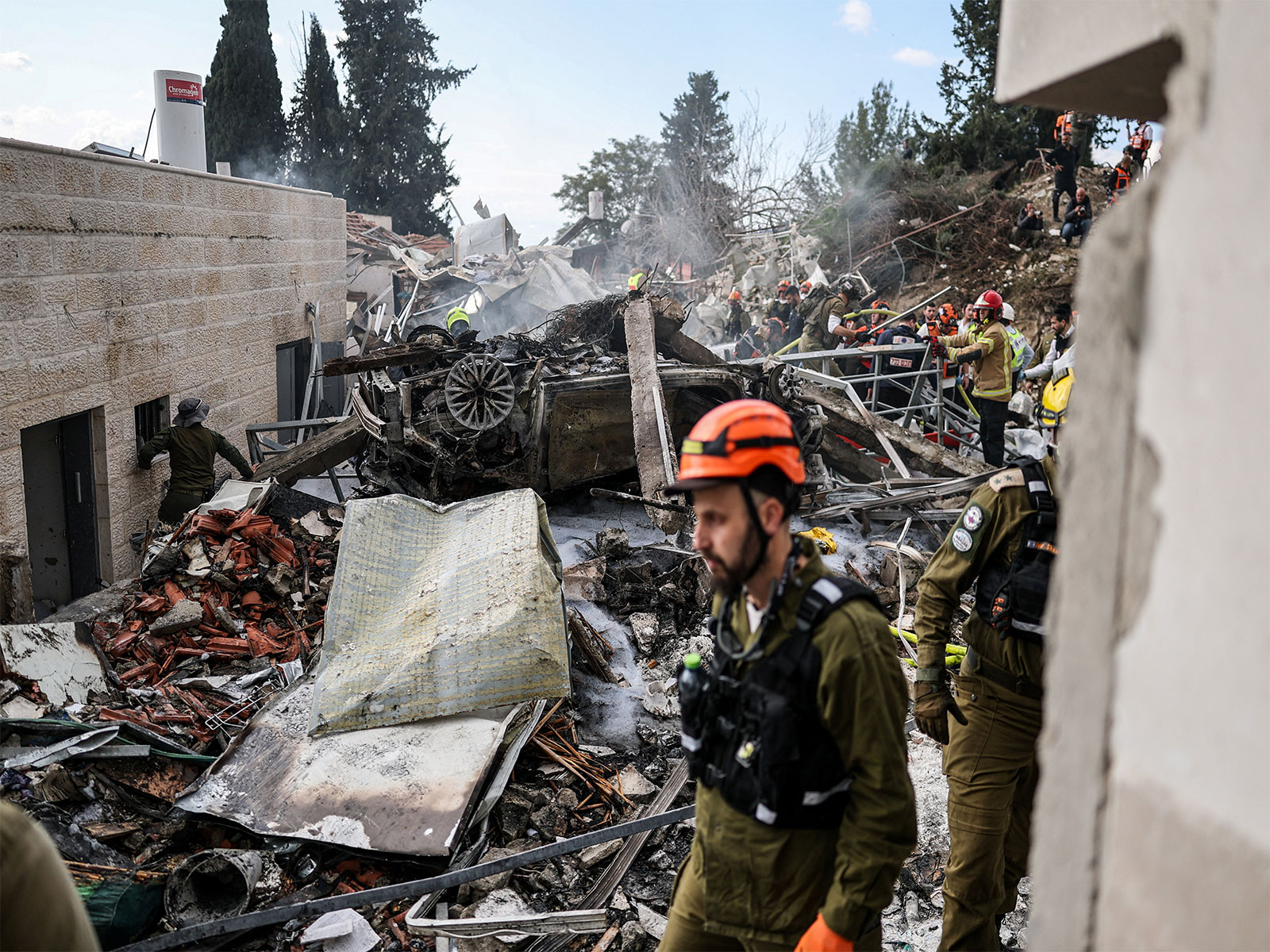 Emergency personnel work at the site of an Iranian strike, after Iran launched missile barrages (Photo/Reuters)