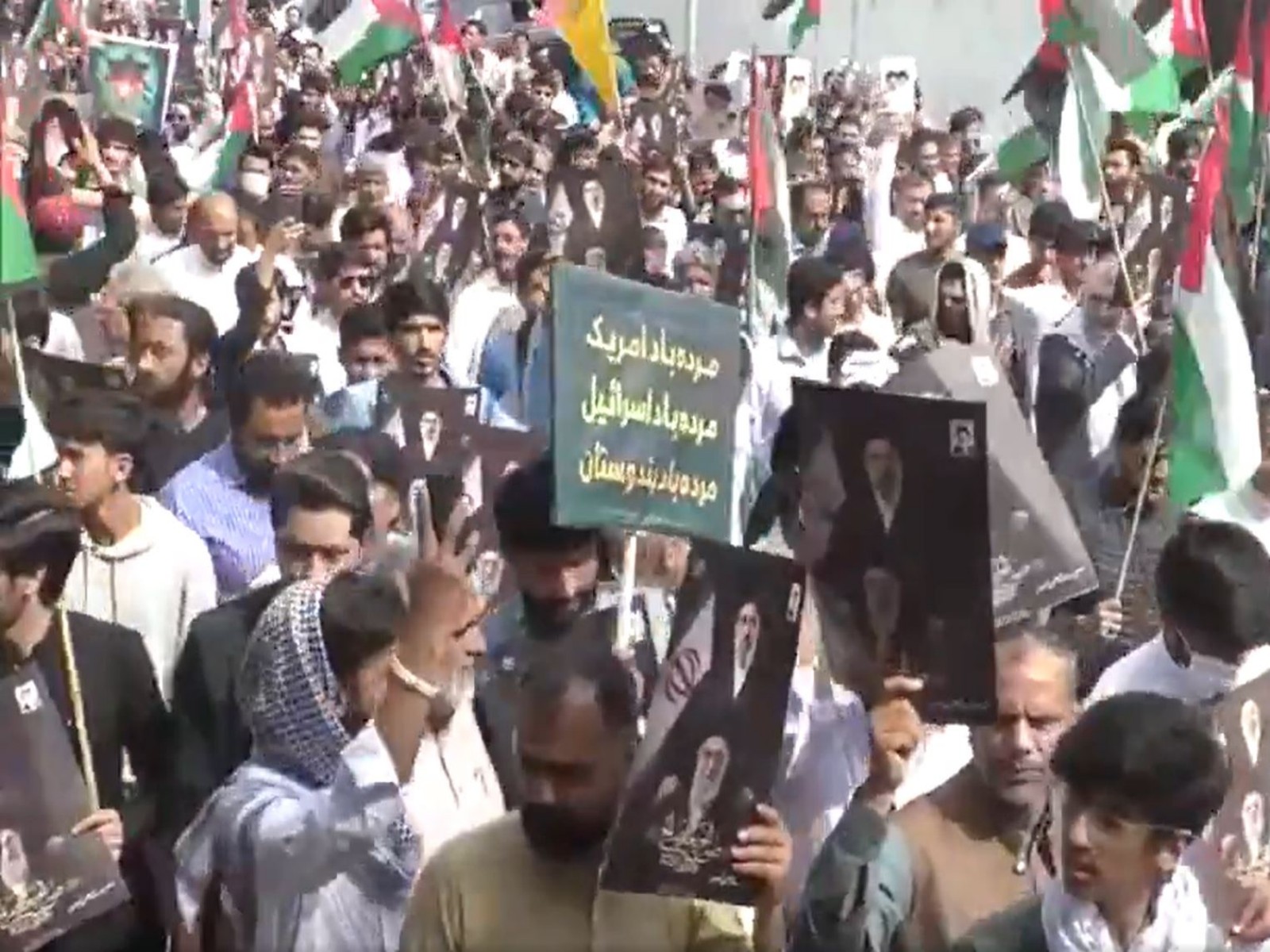 Participants carry flags and portraits during a Youm-e-Quds rally in Islamabad to express support for the Palestinian cause and protest against Israel. (Photo/ANI)