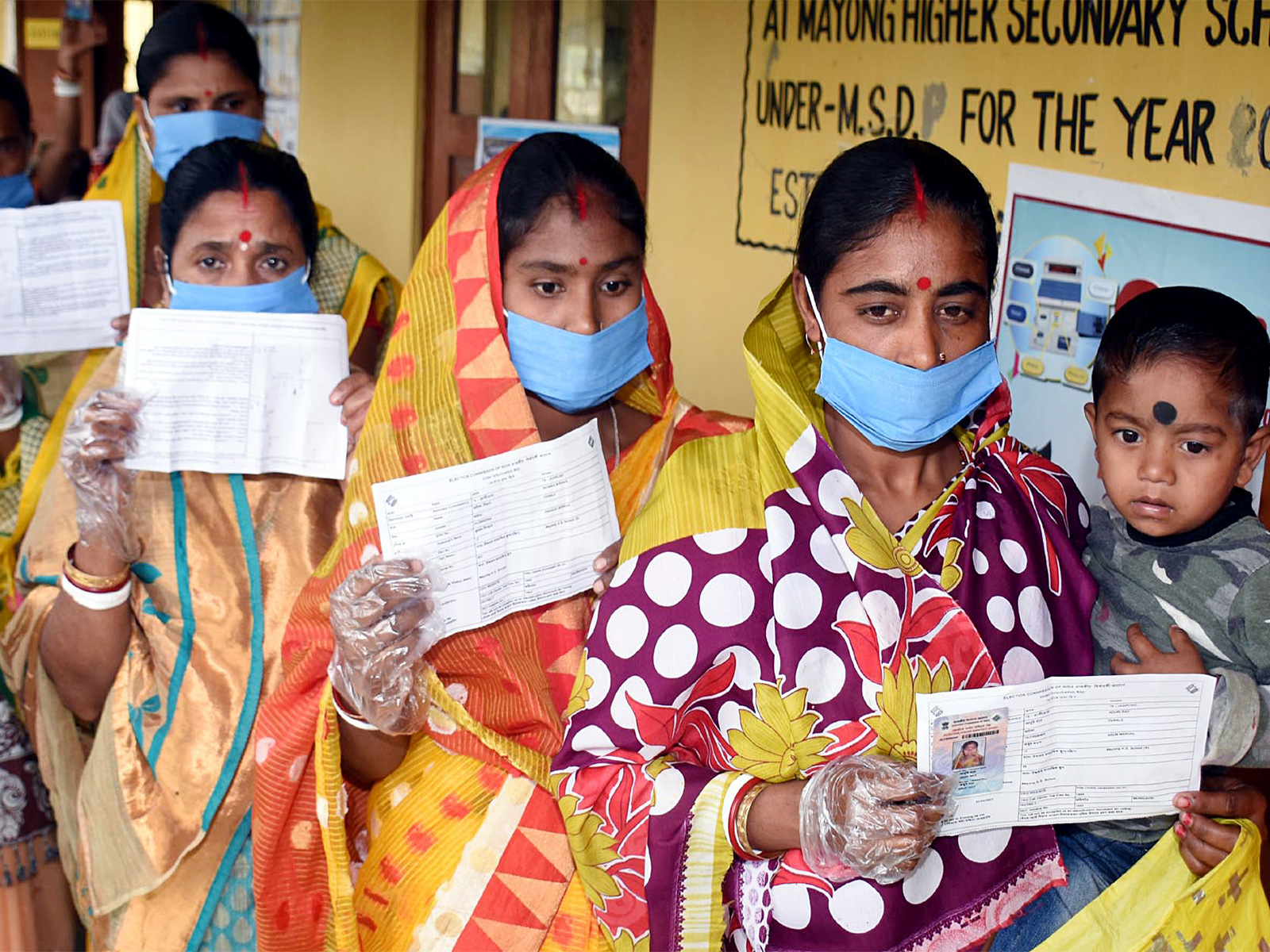 A file photo of people queuing up outside a polling station during 2021 ssembly polls in Assam. (Photo/ANI)