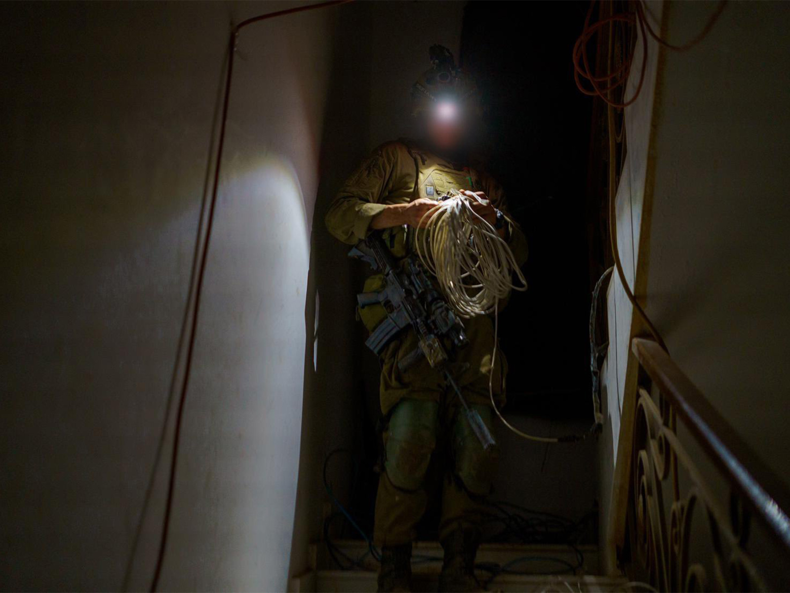 An IDF soldier inspects wiring inside a structure during targeted ground operations against Hezbollah positions in southern Lebanon. (Photo: X/@idfonline)