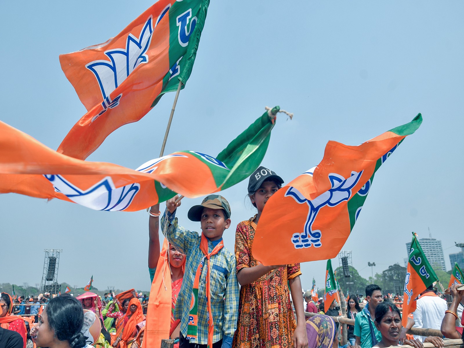 Supporters wave party flags at Brigade Parade Ground during Prime Minister Narendra Modi's rally in Kolkata (FilePhotoANI)