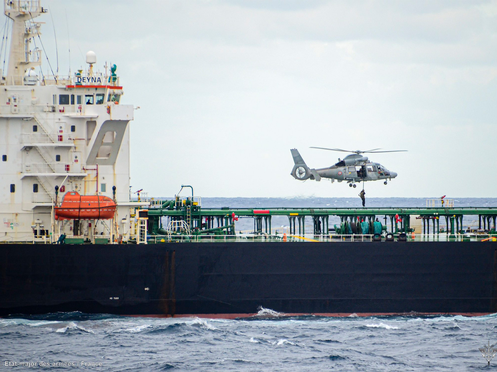 A French Navy helicopter hovers above the vessel Deyna during an interception operation targeting a suspected "ghost fleet" ship involved in sanctions evasion. (Photo: X/@EmmanuelMacron)