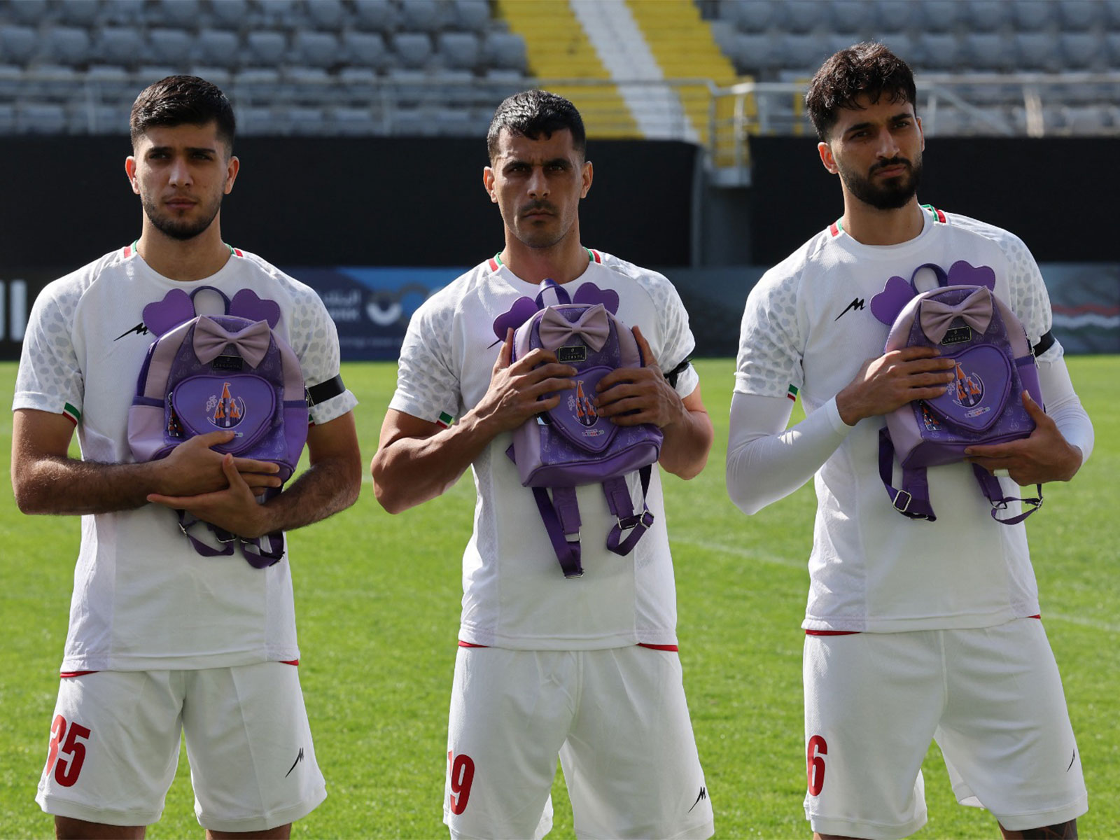 Iran's Aria Yousefi, Ali Nemati and Mohammad Ghorbani hold school bags in memory of the victims of the girls school bombing in Minab. (Photo/Reuters)