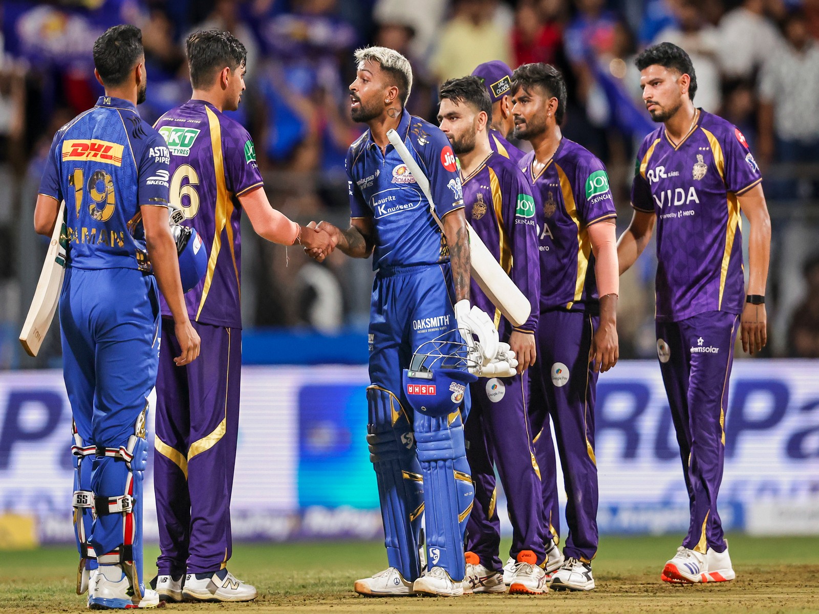 MI and KKR players after the Sunday match (Photo: ANI)