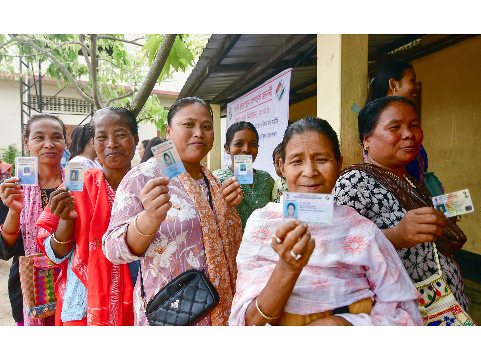 Voters show their voter IDs as they cast their votes at the polling station (Photo/ANI)