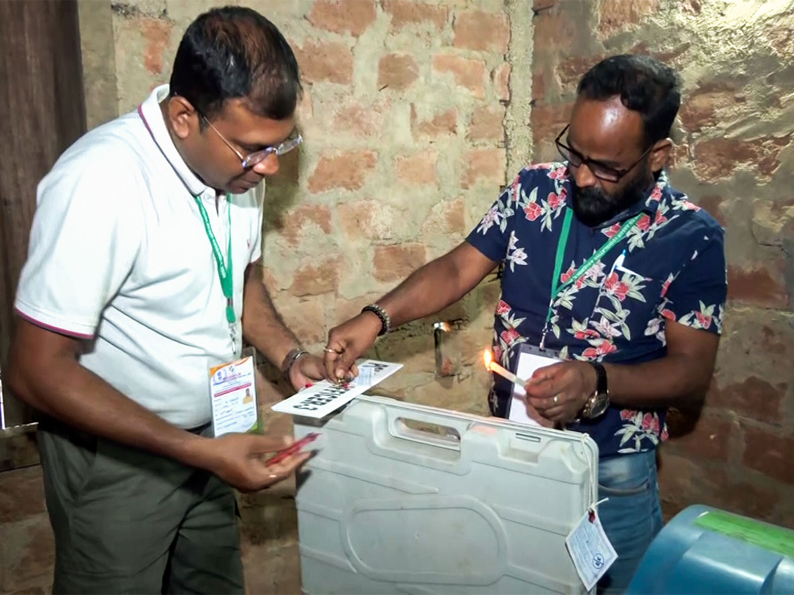 Poll officials seal an EVM in a polling booth in Assam after conclusion of voting (Photo/ANI)