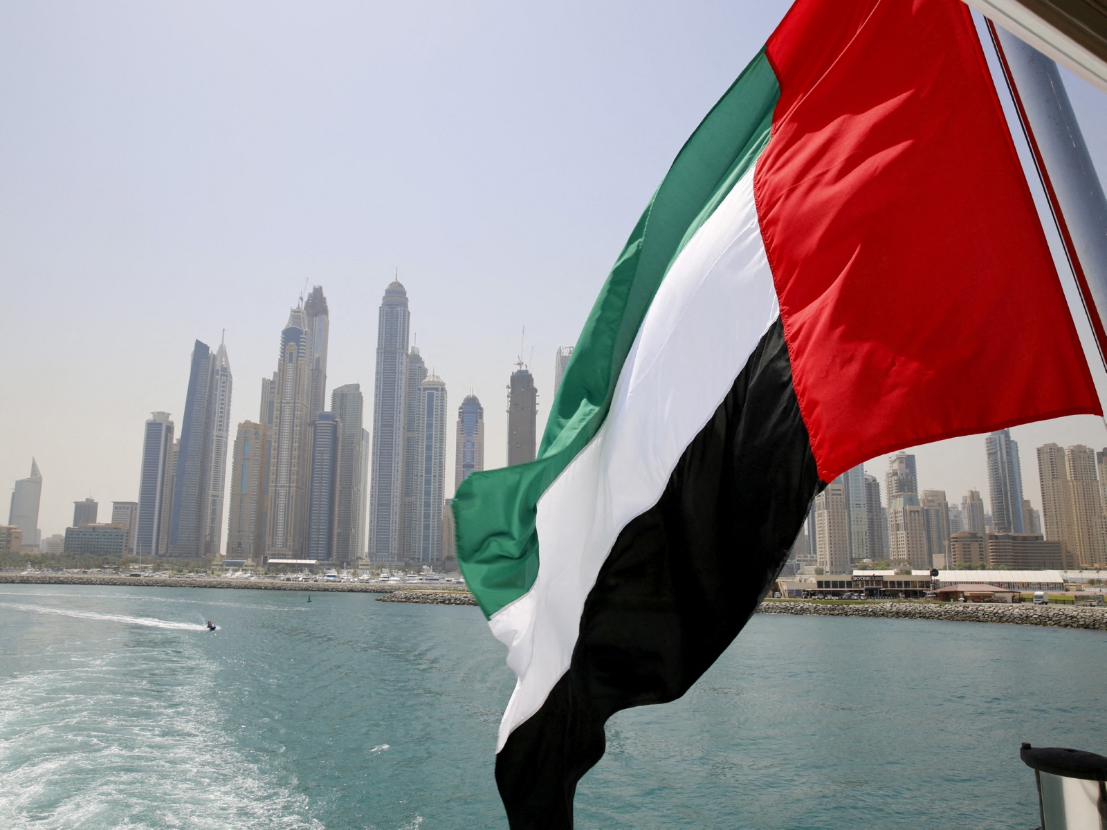 The UAE flag is seen flying atop a boat at Dubai Marina in Dubai, United Arab Emirates. (Photo/Reuters)