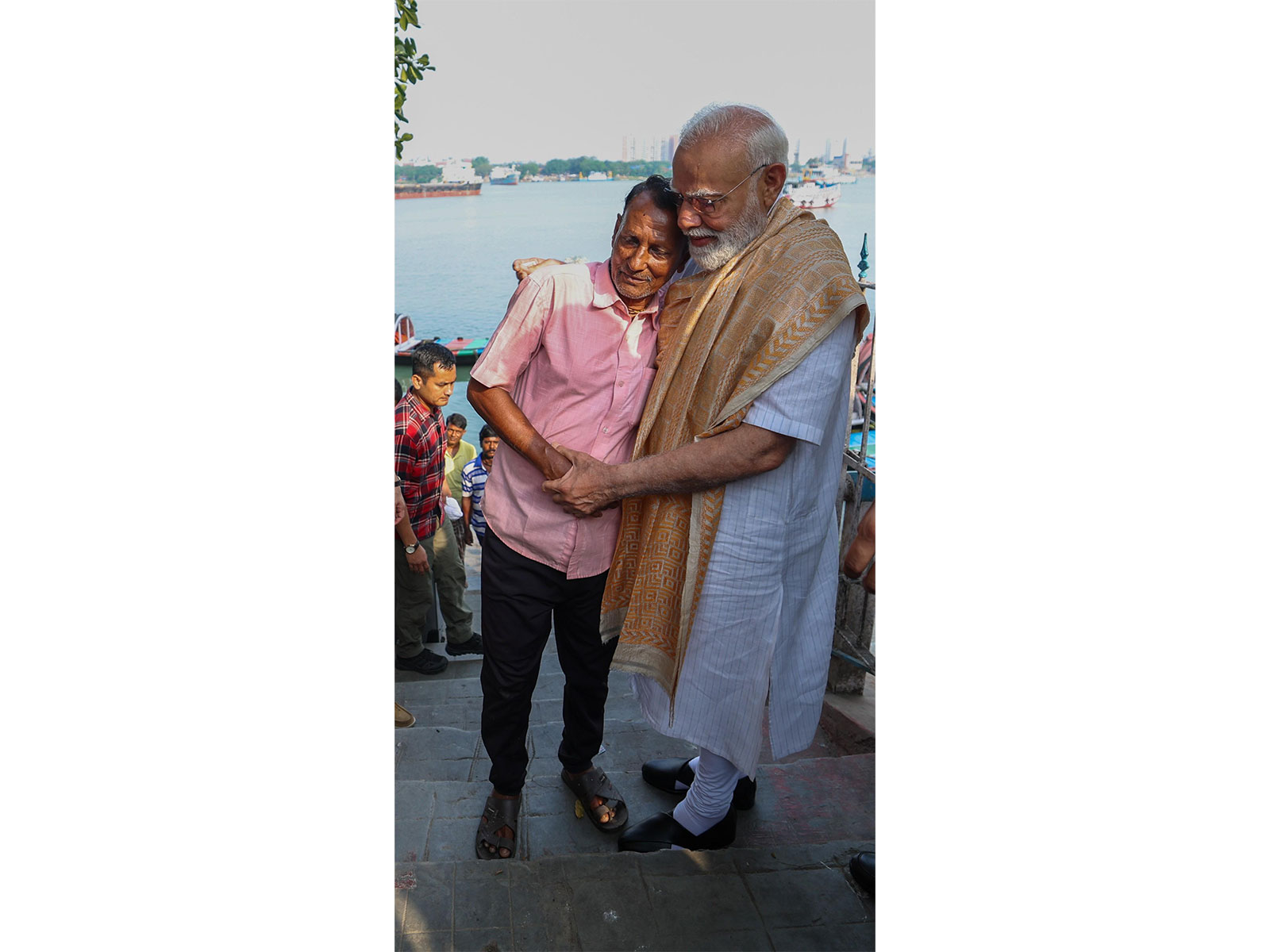 PM Modi giving a warm hug to the boatman. (Photo/ANI)