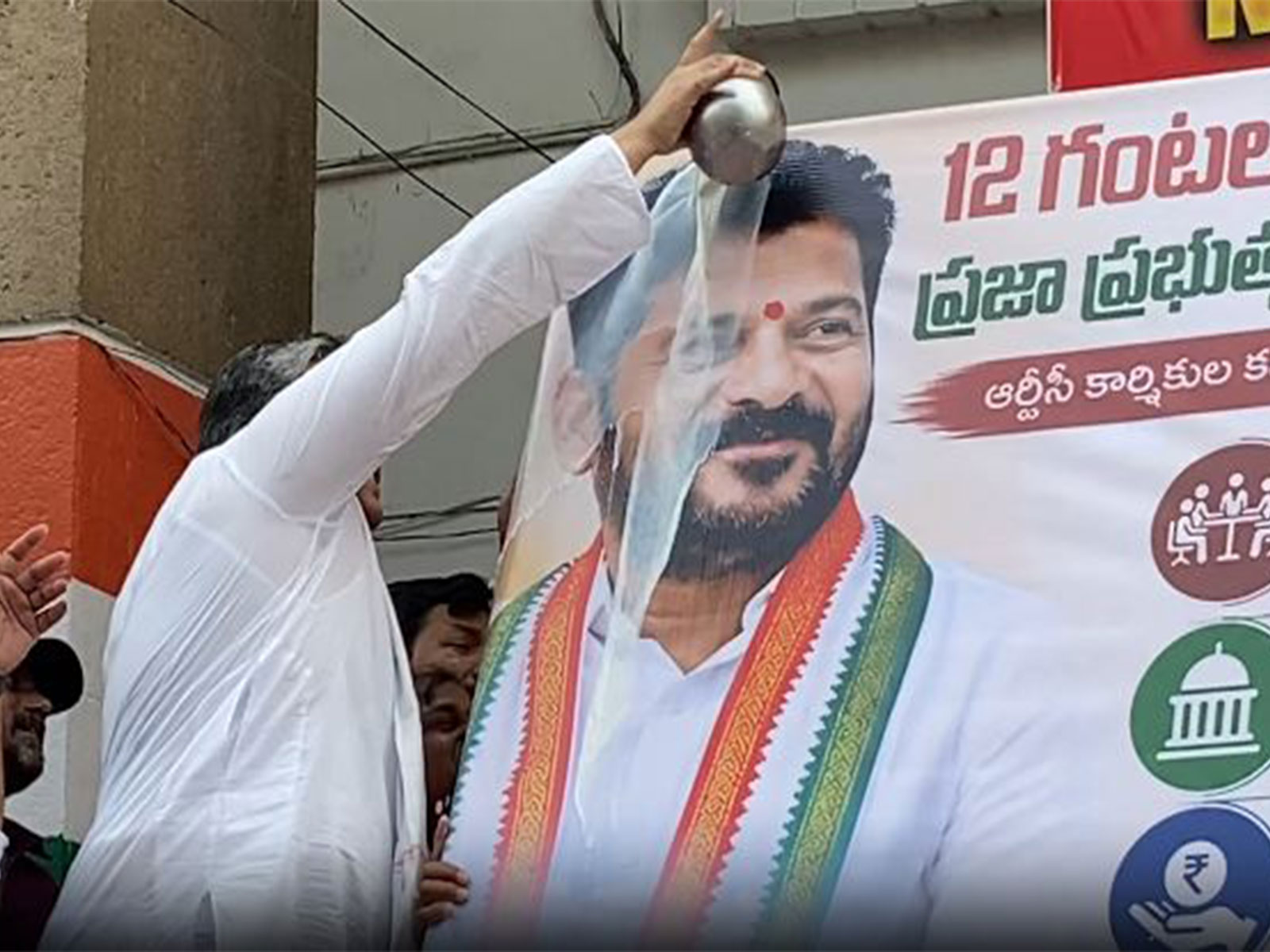 Telangana Congress supporters pouring milk over portrait of Chief Minister Revanth Reddy (Photo/ANI)
