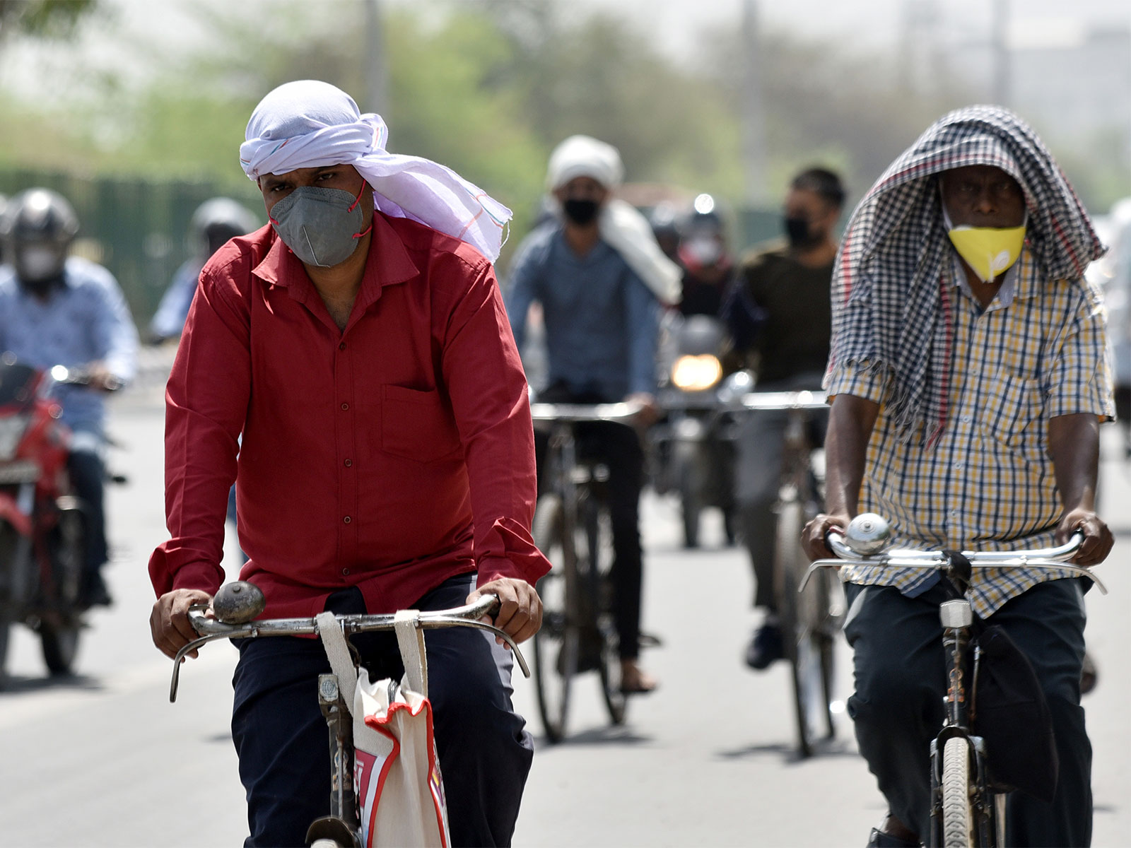 People cover their faces and heads to protect themselves from scorching heat (File Photo/ANI)