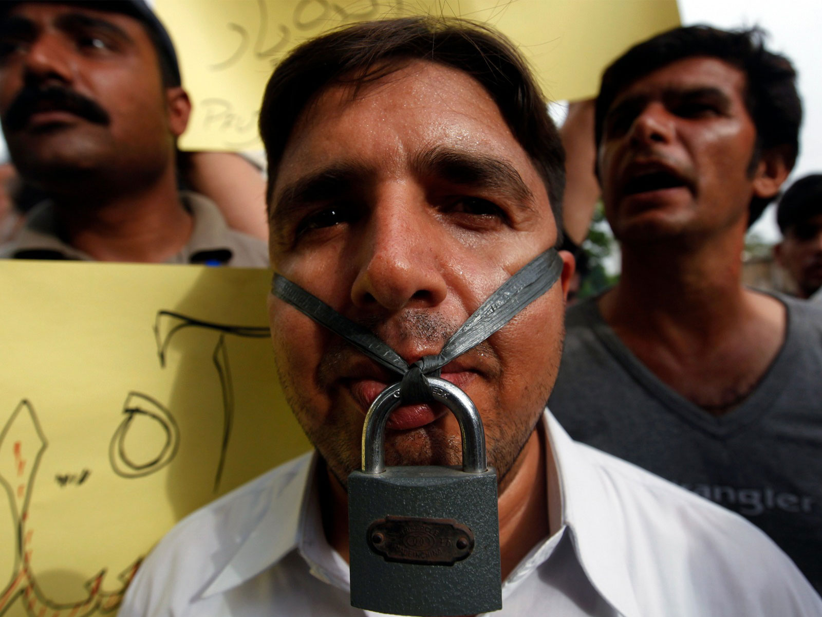 A journalist hangs a lock across his lips during a protest against the freedom of press in Karachi (File Photo/ Reuters)