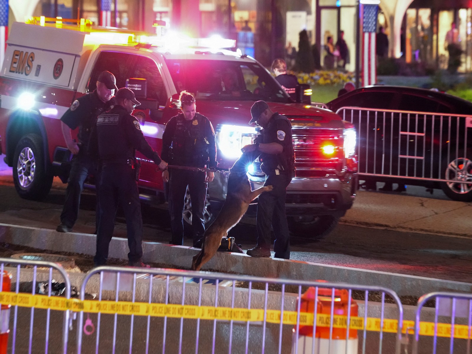 A police K-9 Unit officer stands with other law enforcement personnel at the venue following a shooting incident during the annual White House Correspondents' Association dinner, in Washington (Photo/ Reuters)