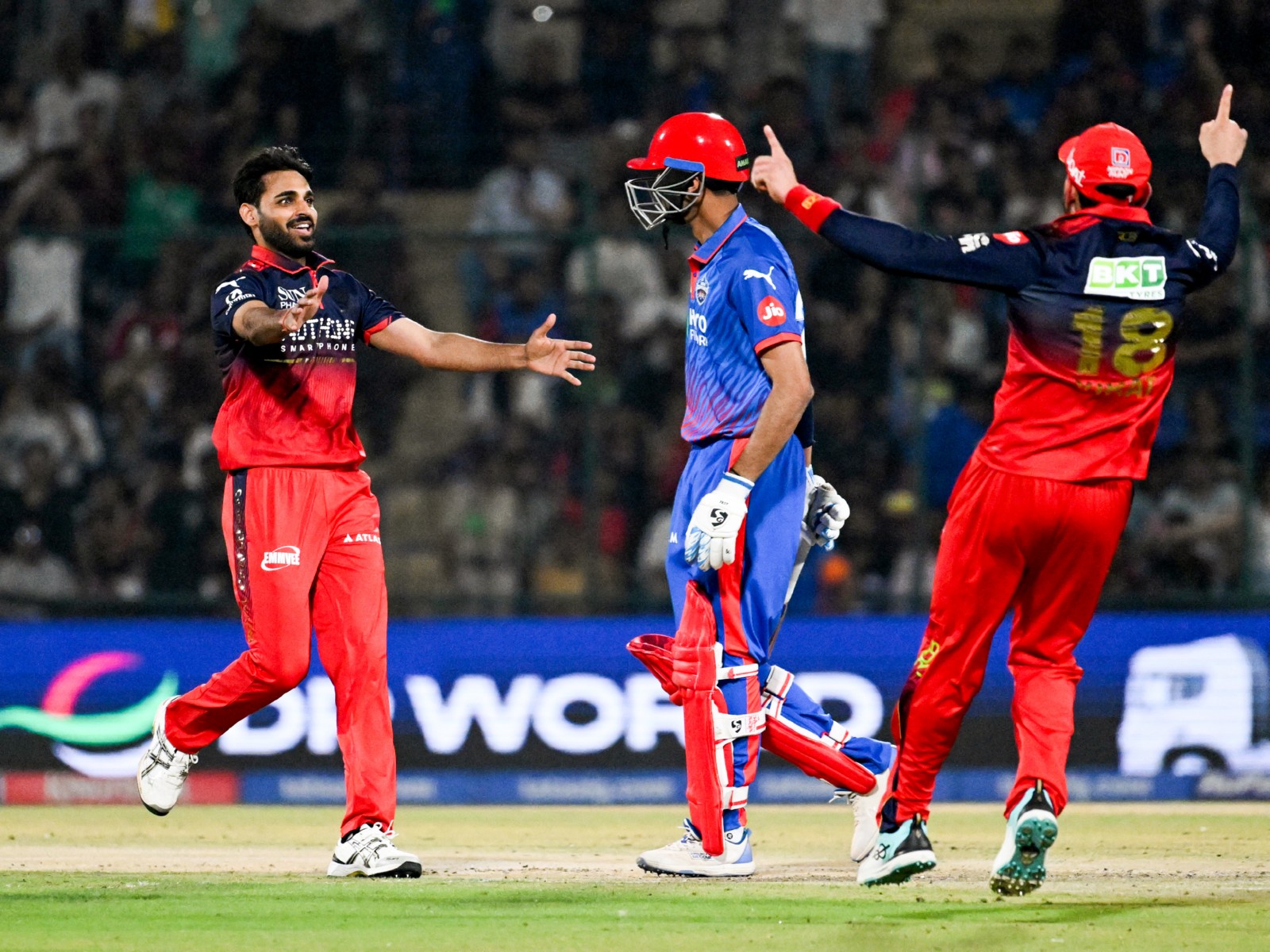 DC and RCB players in action (Photo: ANI)