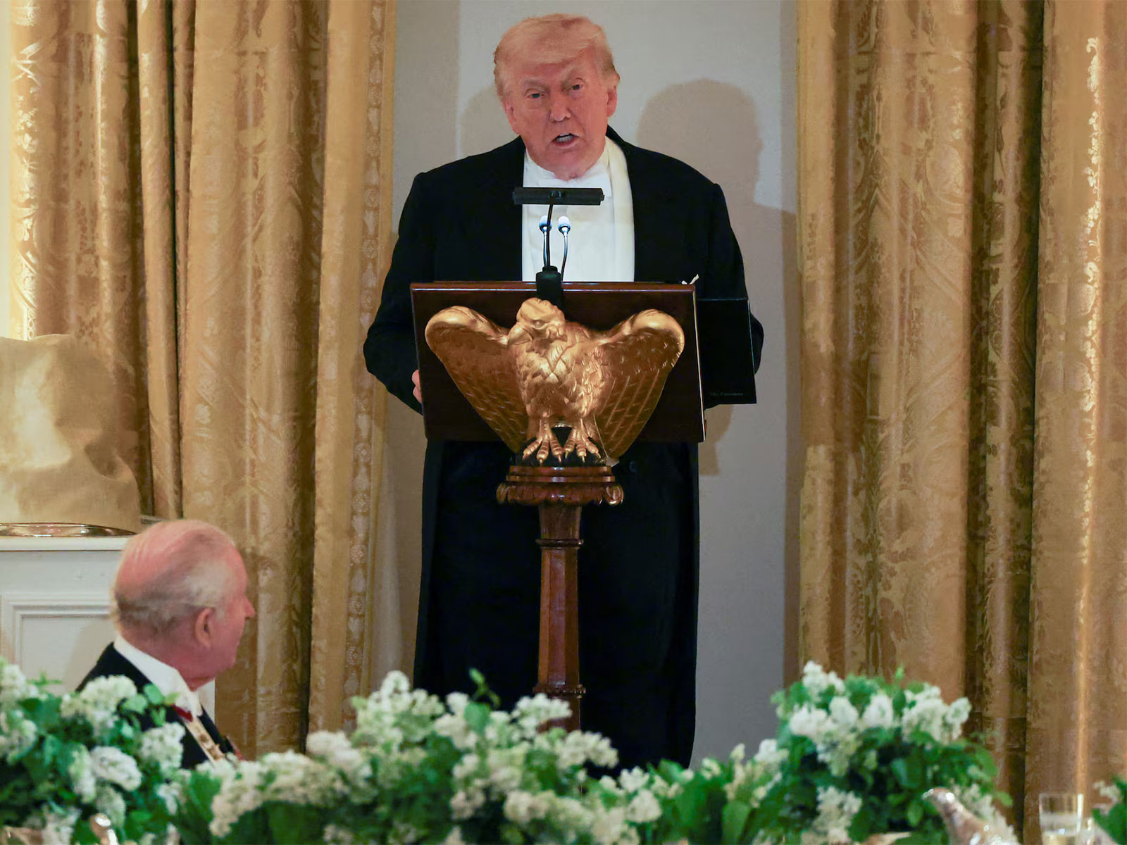 Britain's King Charles III listens as US President Donald Trump delivers remarks during a state dinner. (Photo/Reuters)