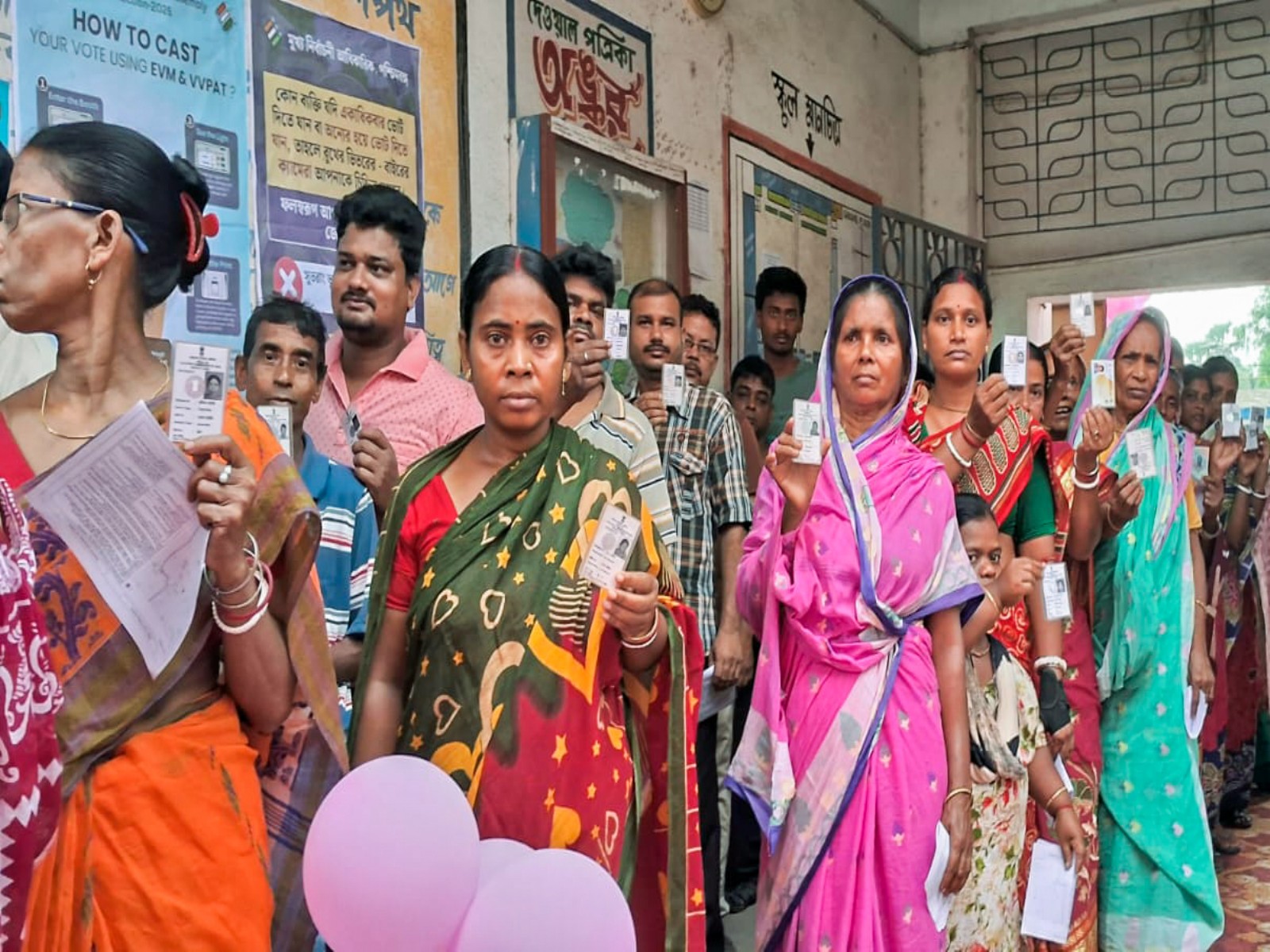 People show their voter IDs as they stand in queues to cast votes during second phase of polling in Howrah (Photo/ANI)