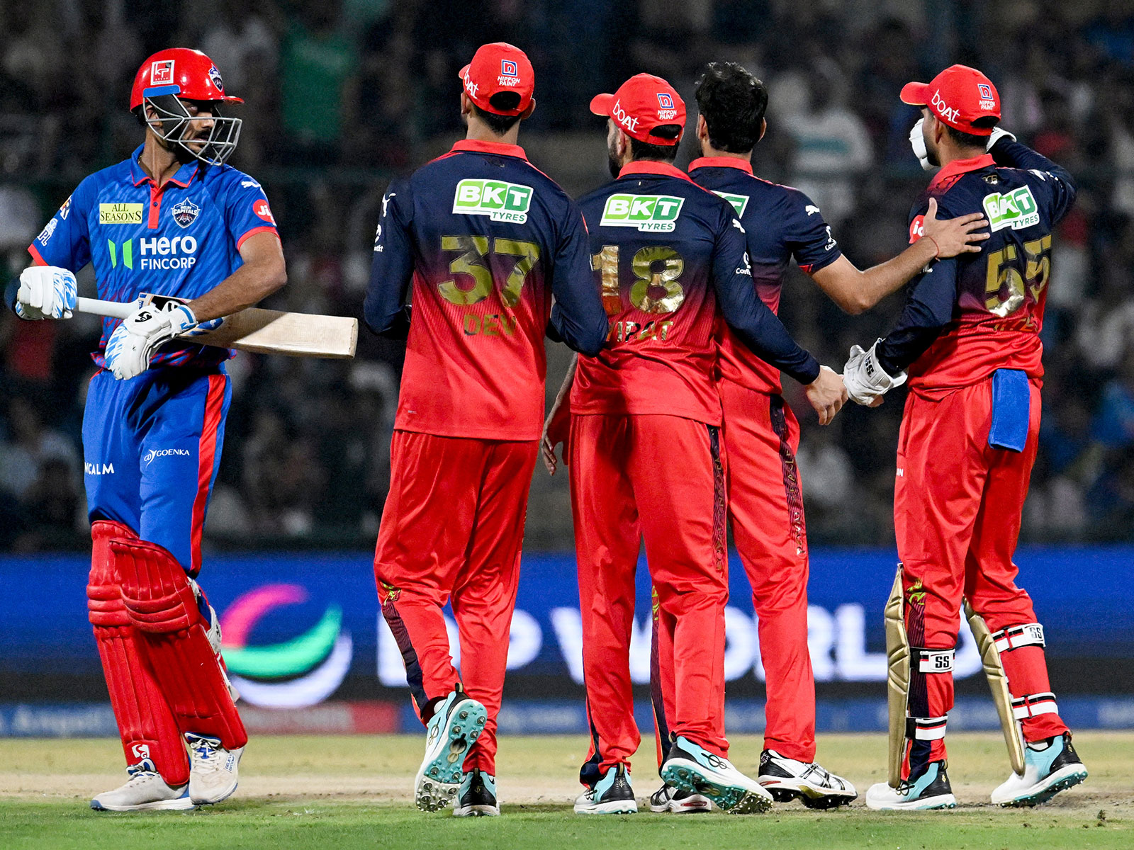 DC' skipper Axar Patel (left) walking after losing his wicket against RCB (Photo: ANI)
