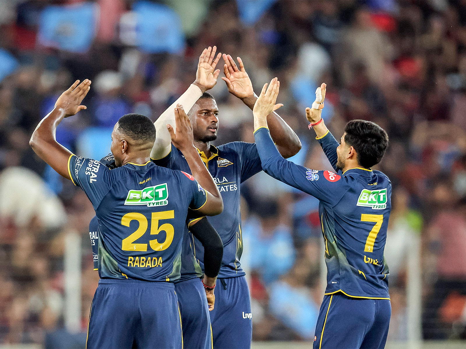 Gujarat Titans' Jason Holder (middle) and teammates (Photo: ANI)