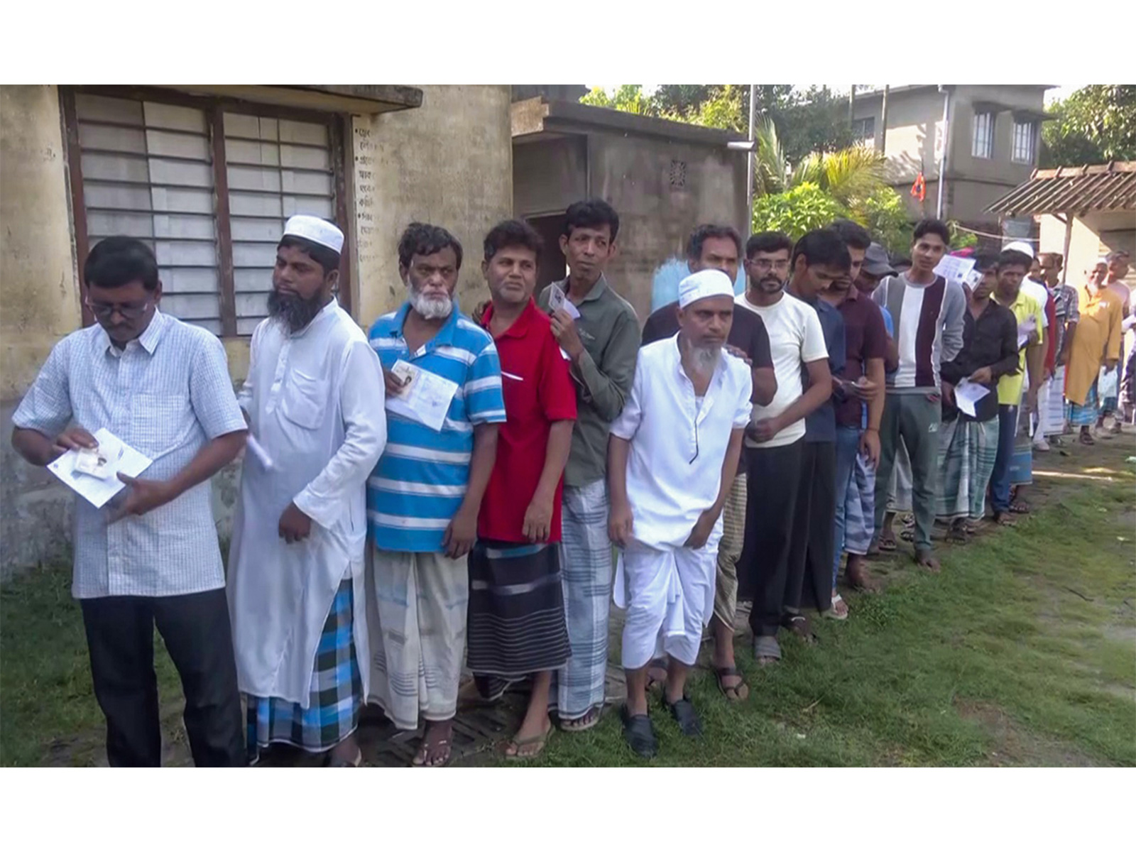 Voters stand in a queue to cast their vote (Photo/ANI)