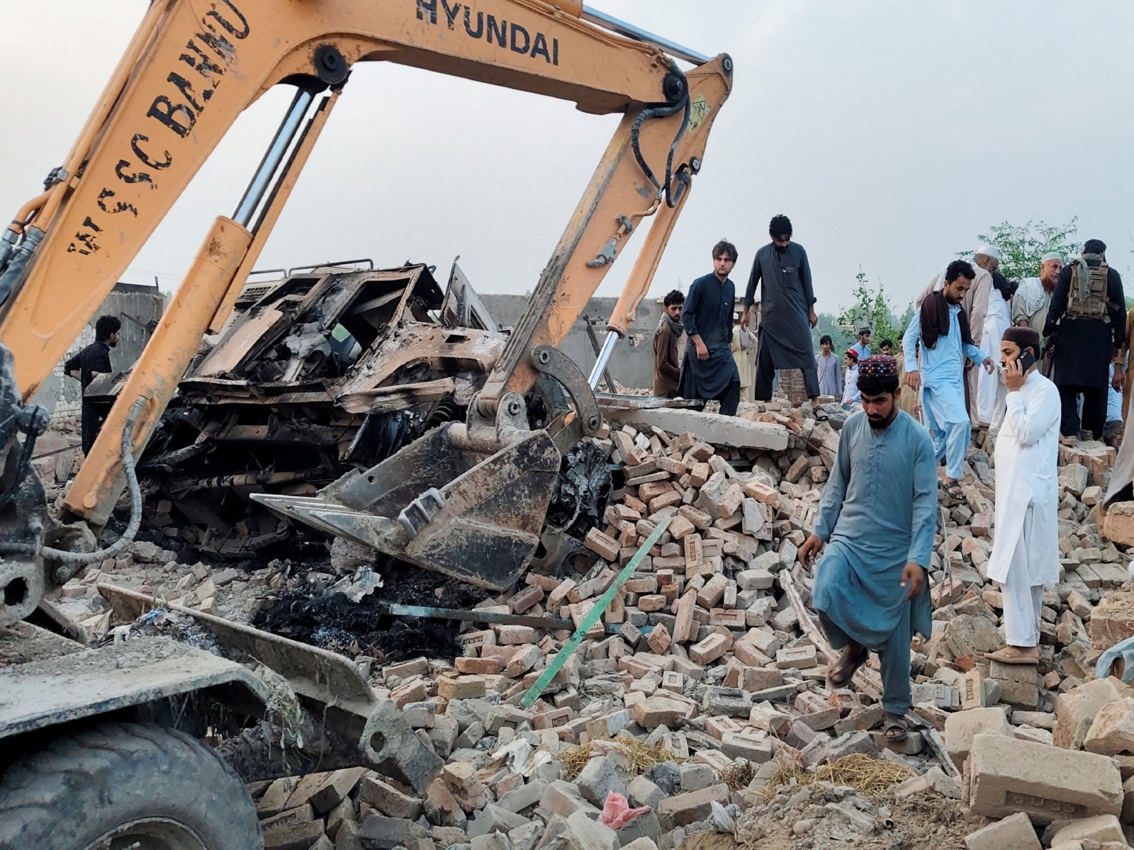 Residents gather on the rubble of a damaged police post after a car bombing in Bannu, Khyber Pakhtunkhwa province, Pakistan (Photo/Reuters)