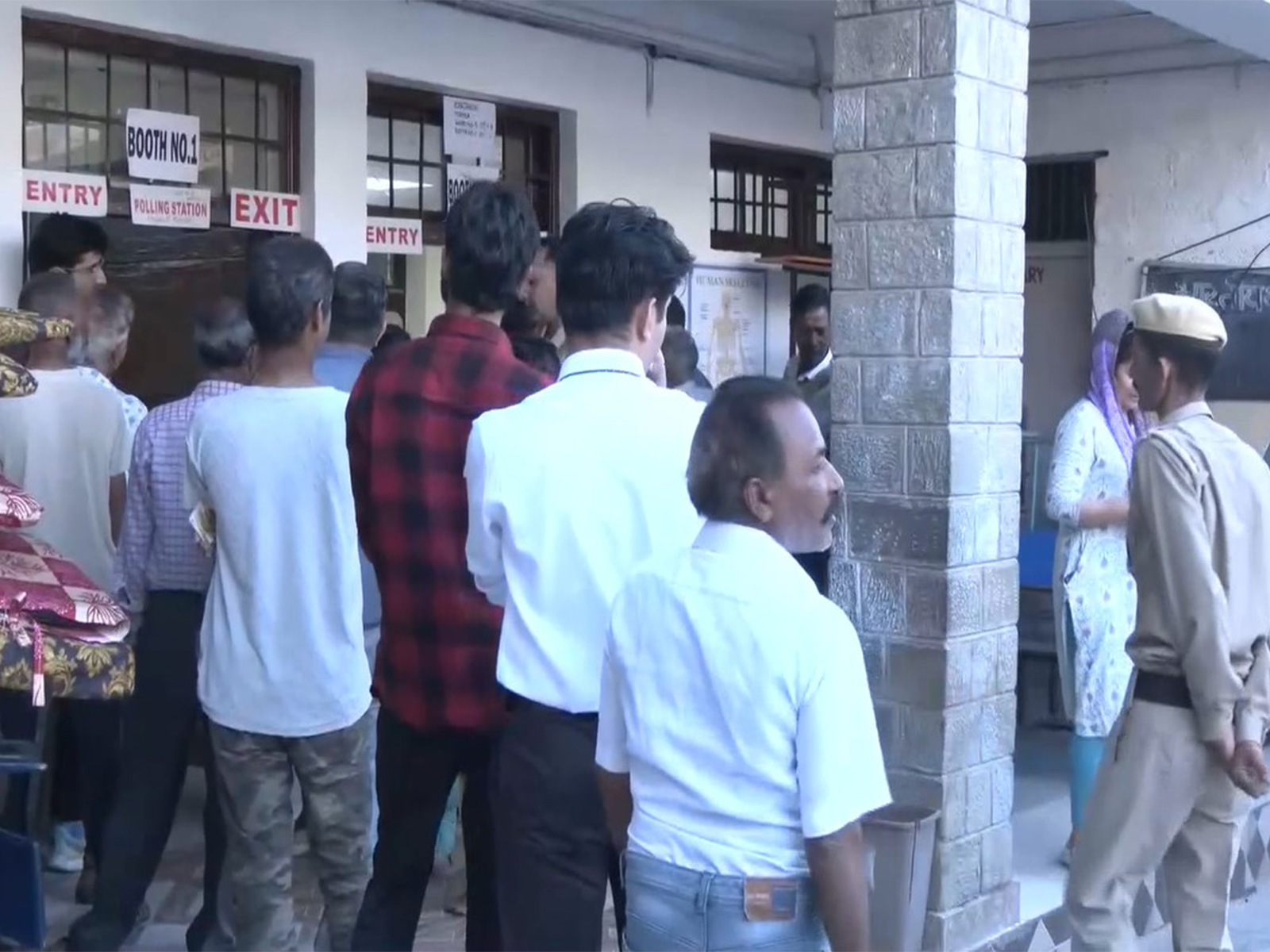 Voters queue up at a polling station in Dharamshala to cast vote for civic body elections (Photo/ANI)