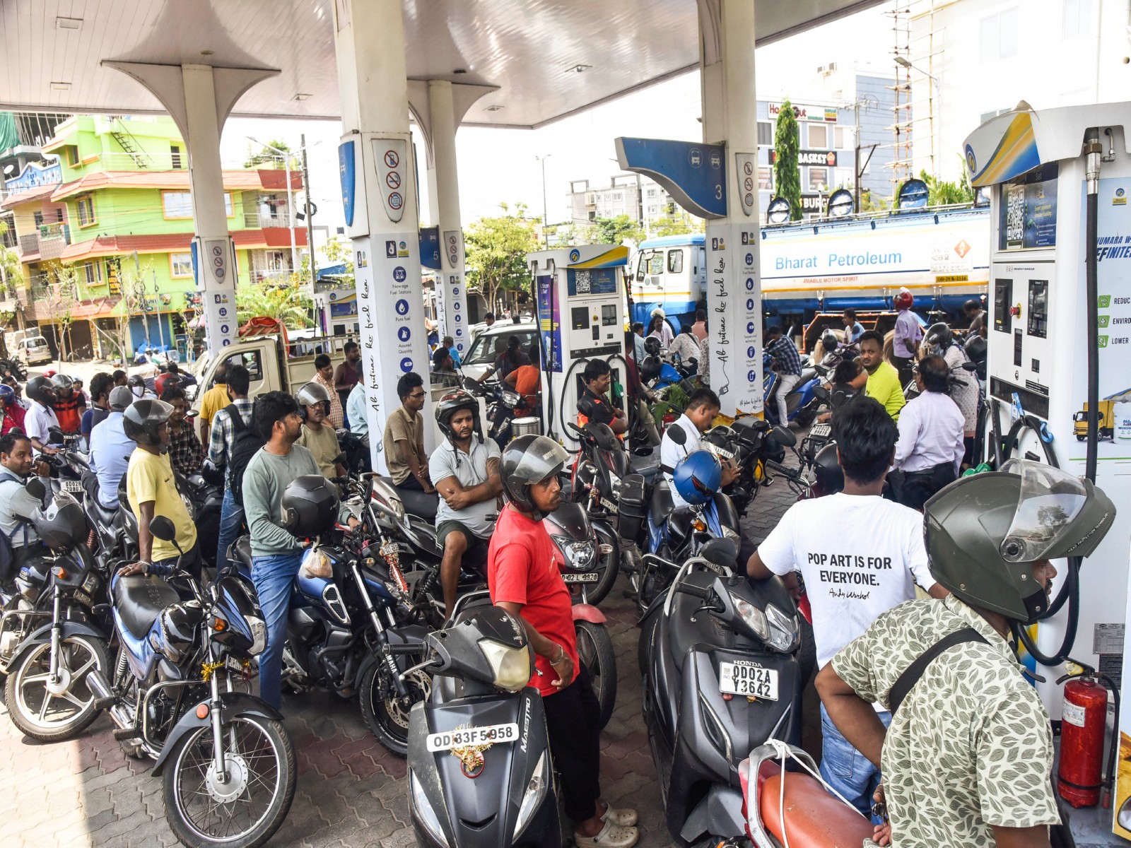 A large crowd of people on two-wheelers queues up at petrol pump (Photo/ANI)