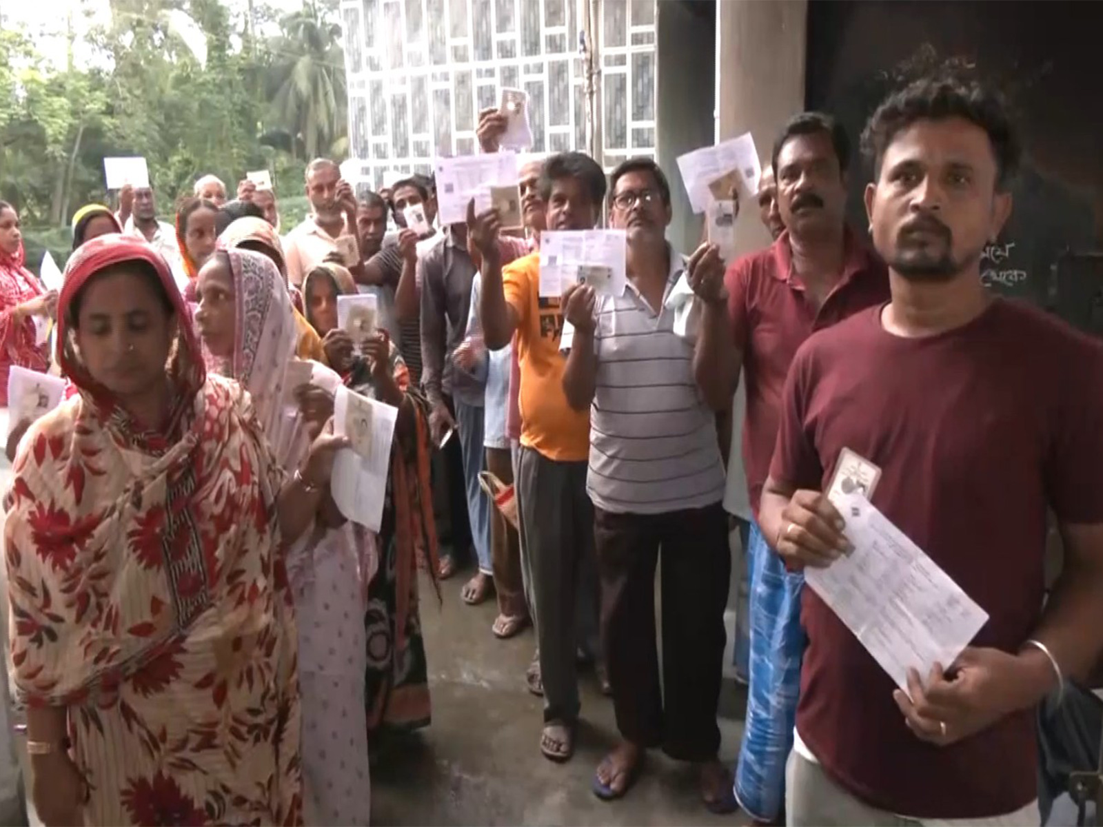 Voters queue up at a polling station to cast vote for the ongoing repolling at Falta assembly constituency (Photo/ANI)
