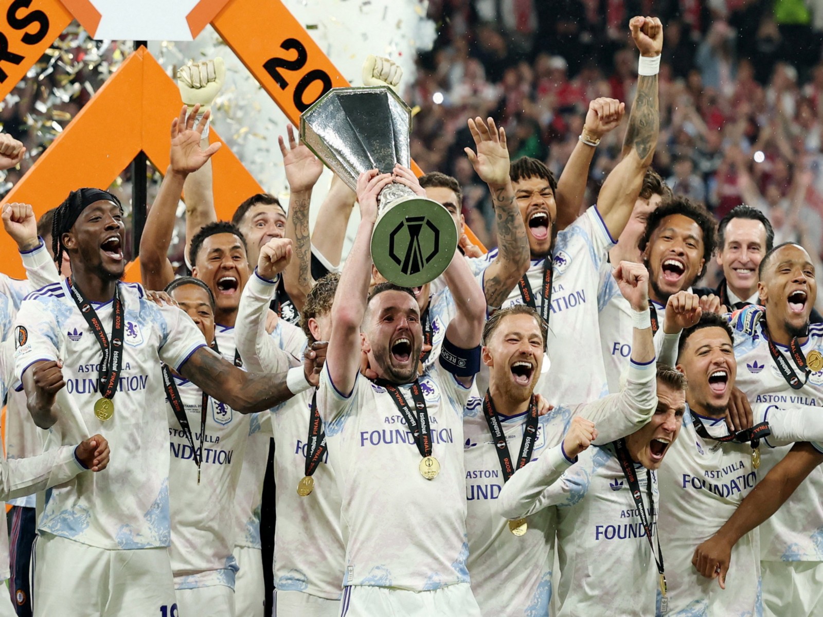 Aston Villa's John McGinn lifts the Europa League trophy as he celebrates with teammates after winning. (Photo: Reuters)